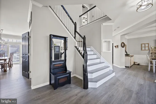 a living room with stainless steel appliances furniture a fireplace and a flat screen tv