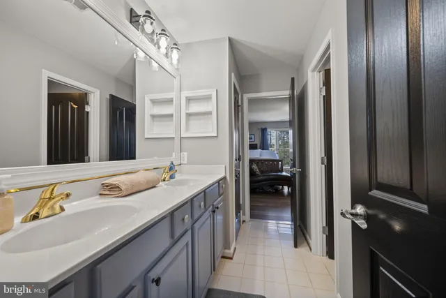a view of a patio with couches table and chairs with potted plants and big trees