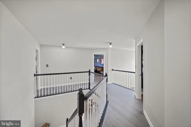 a kitchen with stainless steel appliances granite countertop a sink a stove and a wooden cabinets