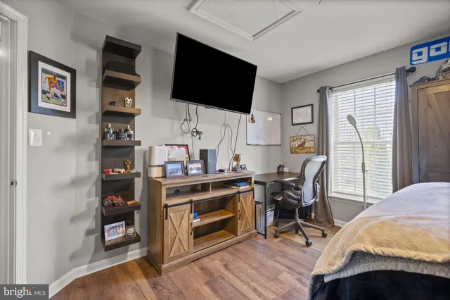 a front view of house with yard and trees in the background