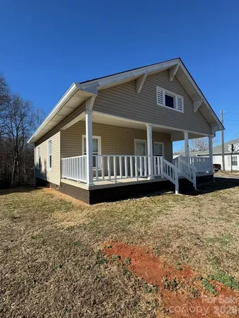 a front view of a house with wooden fence