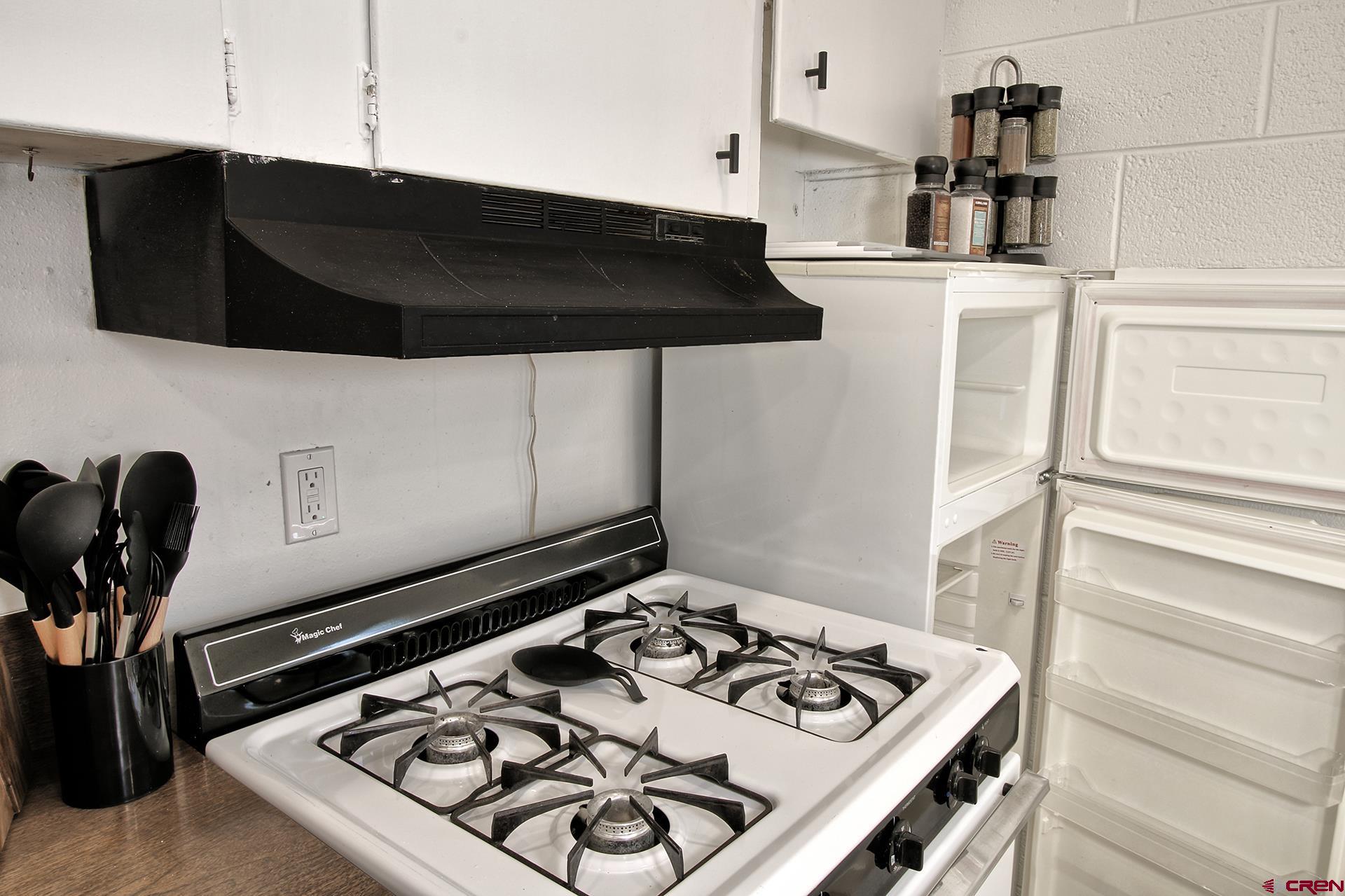 823 Main Street Delta, CO 81416 - Photo 11 of 32 a kitchen with a stove and a microwave