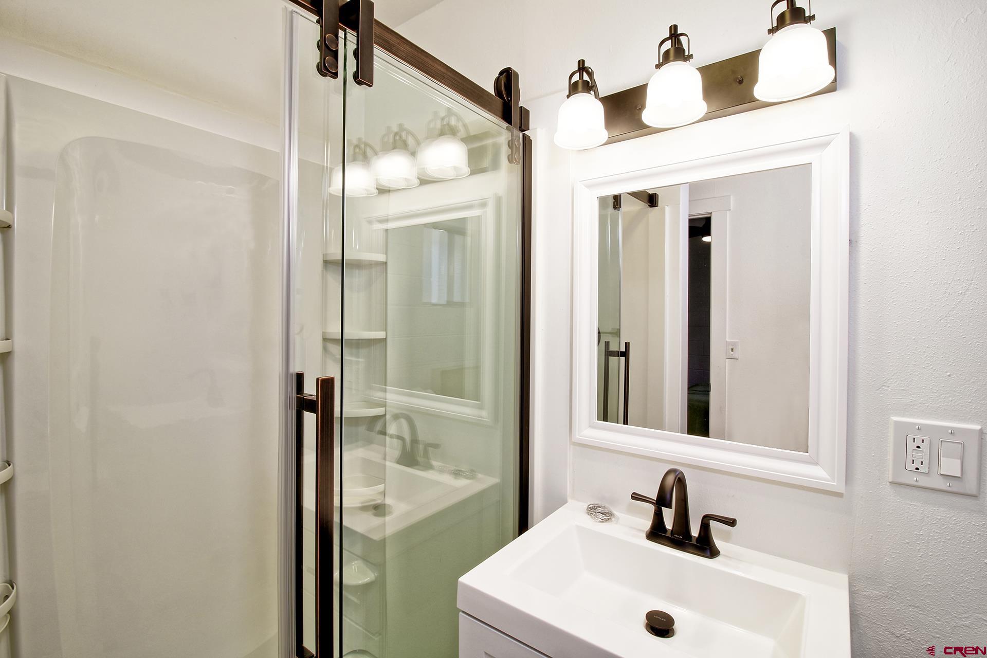 823 Main Street Delta, CO 81416 - Photo 17 of 32 a bathroom with a sink and a mirror
