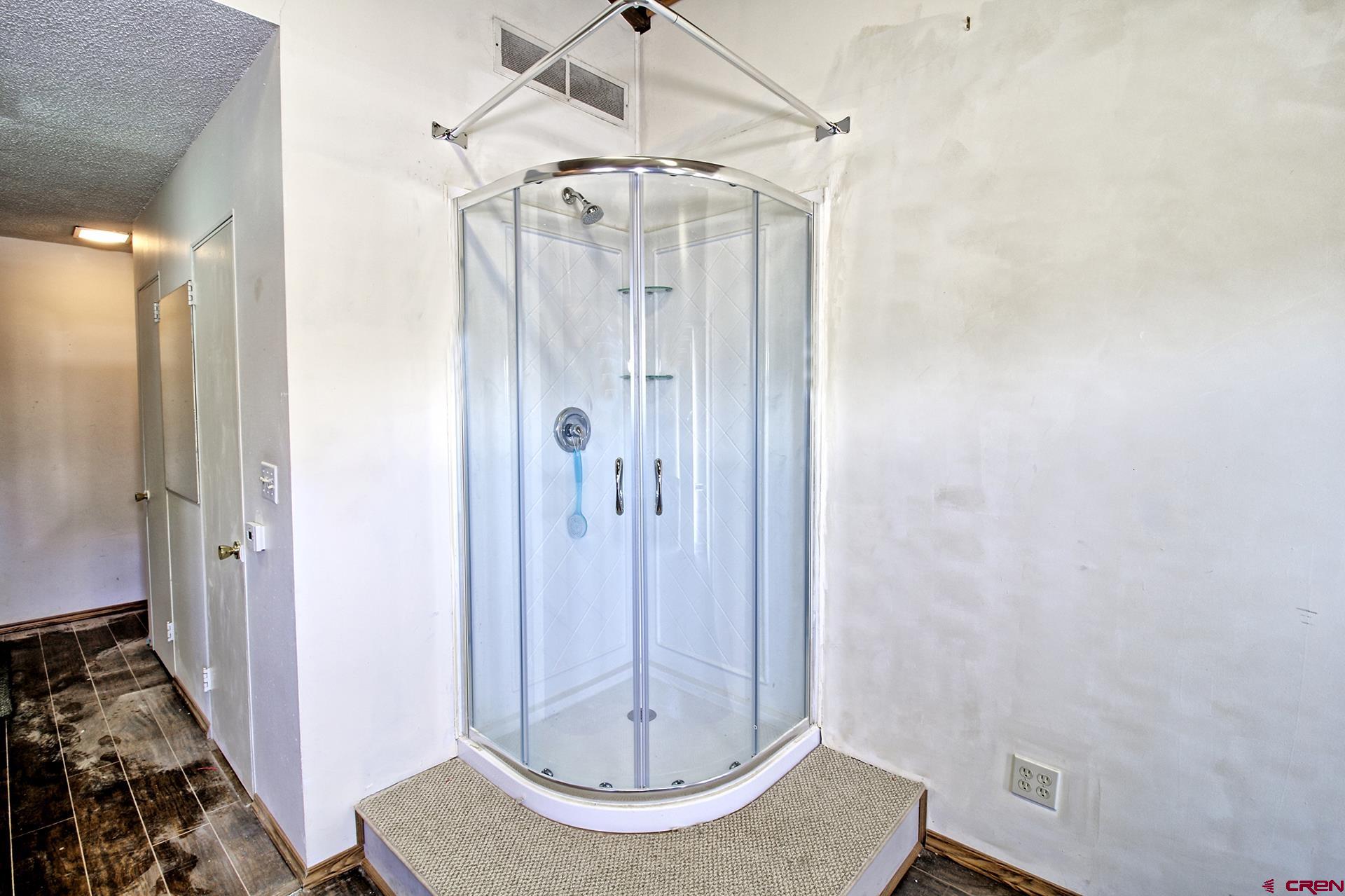 823 Main Street Delta, CO 81416 - Photo 24 of 32 a bathroom with a mirror and a shower