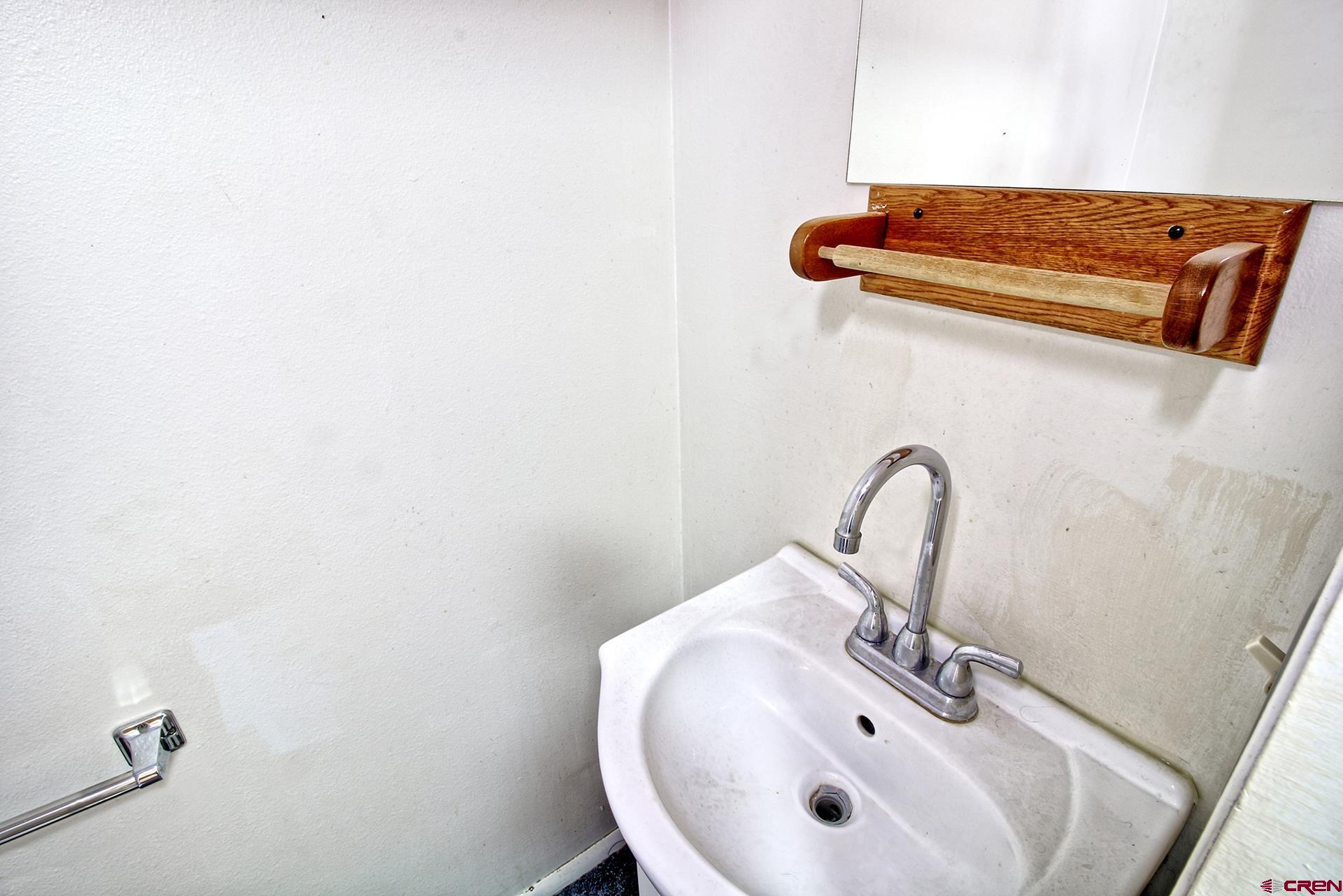 823 Main Street Delta, CO 81416 - Photo 25 of 32 a bathroom with a sink and mirror