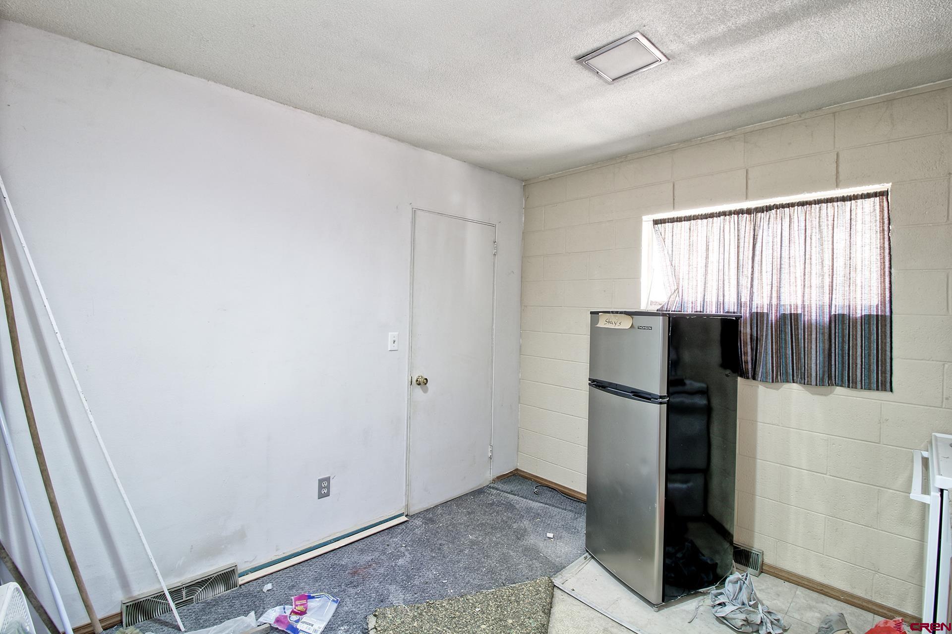 823 Main Street Delta, CO 81416 - Photo 28 of 32 a view of a refrigerator in kitchen and a window