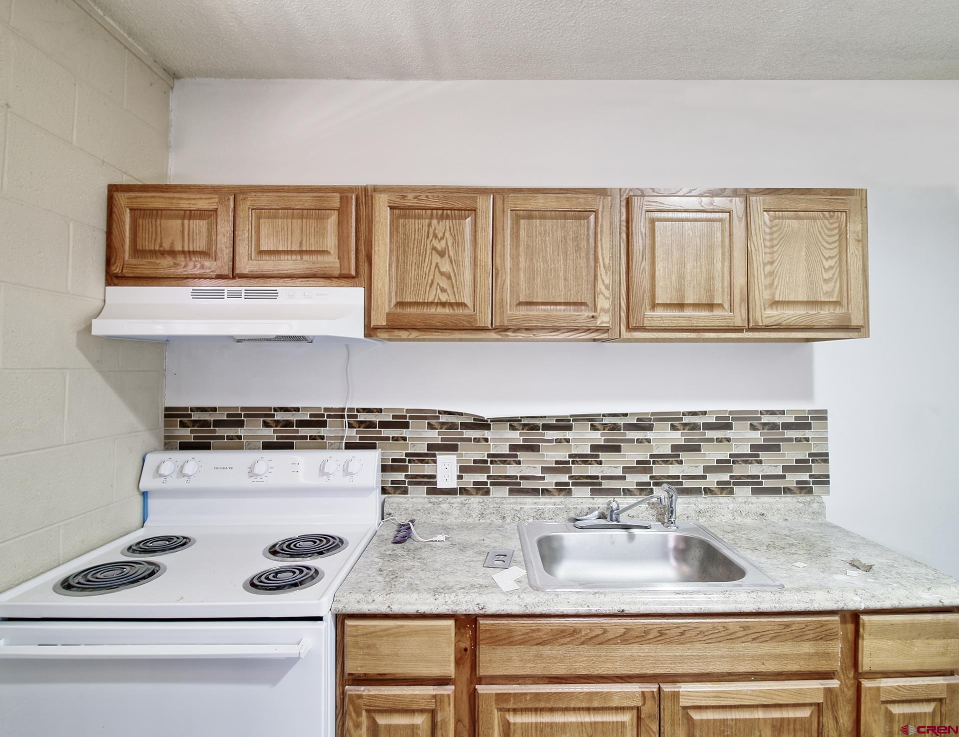 823 Main Street Delta, CO 81416 - Photo 30 of 32 a kitchen with a stove and a cabinets