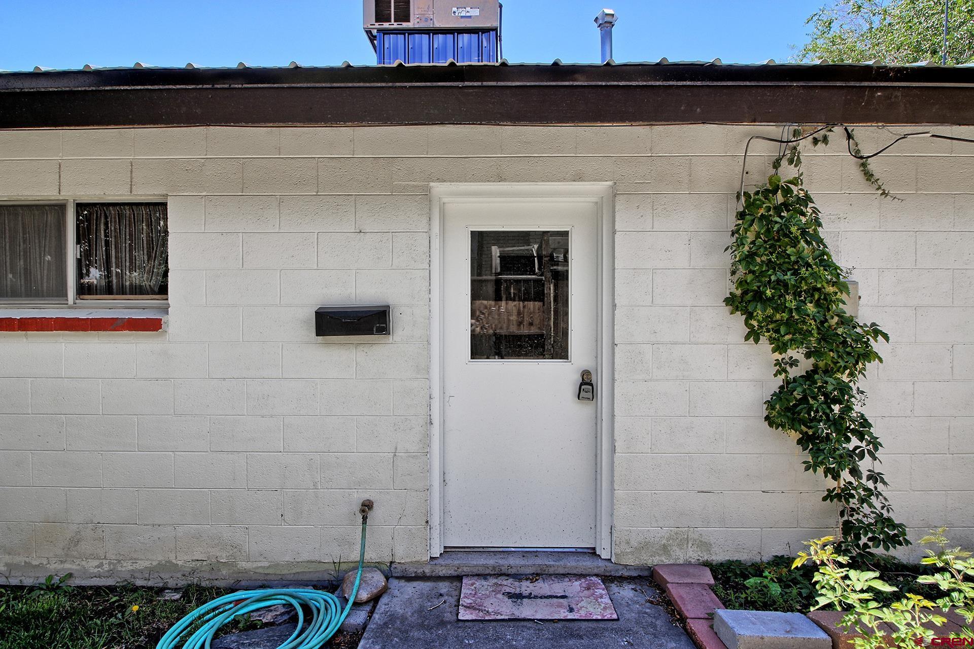 823 Main Street Delta, CO 81416 - Photo 6 of 32 a front view of a house with plants