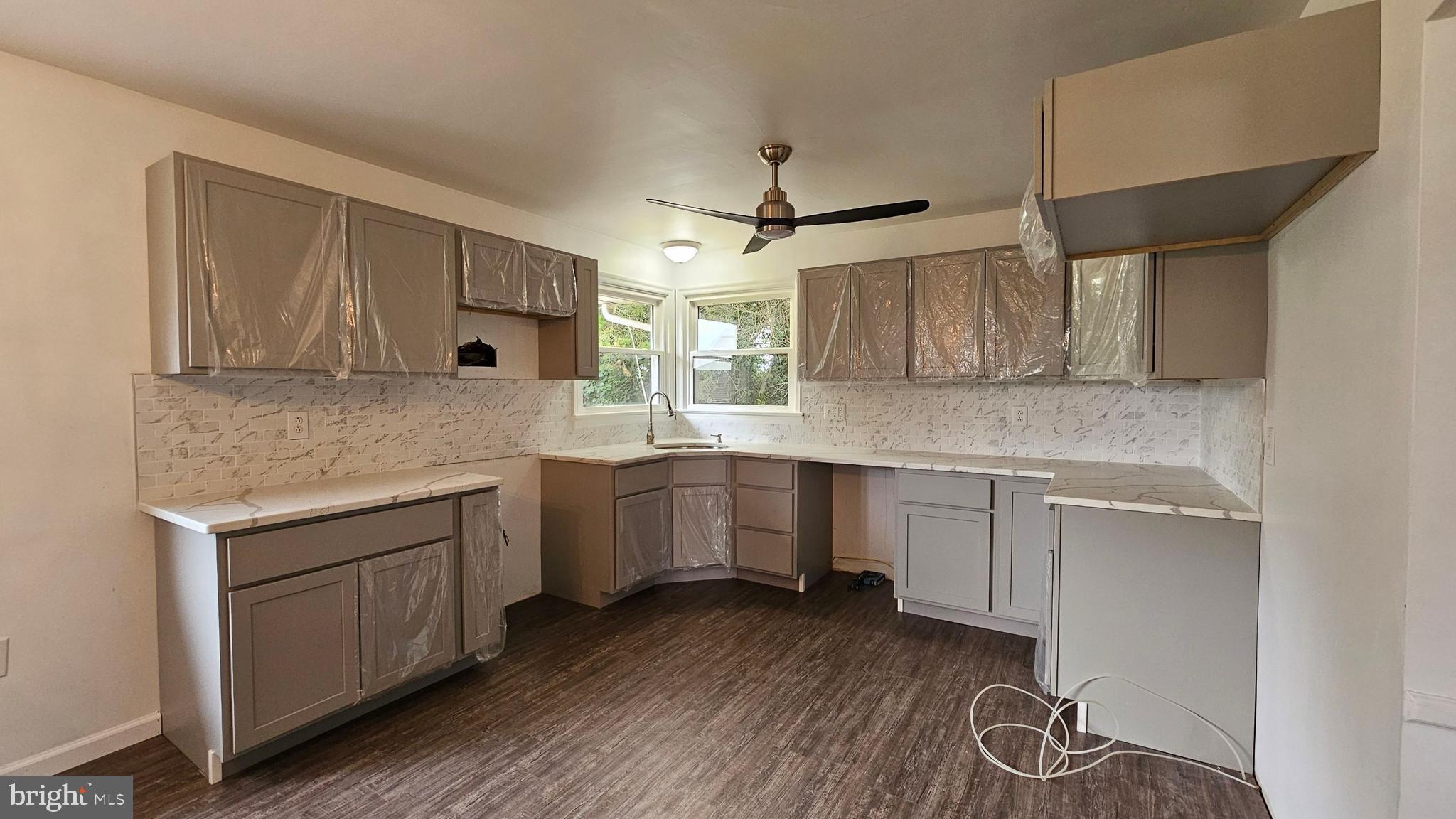 262 Roadstown Road Bridgeton, NJ 08302 - Photo 11 of 25 a kitchen with wooden cabinets and white appliances