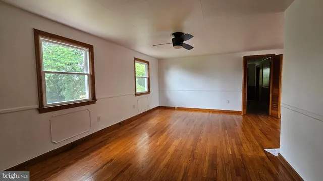 wooden floor in an empty room with a window