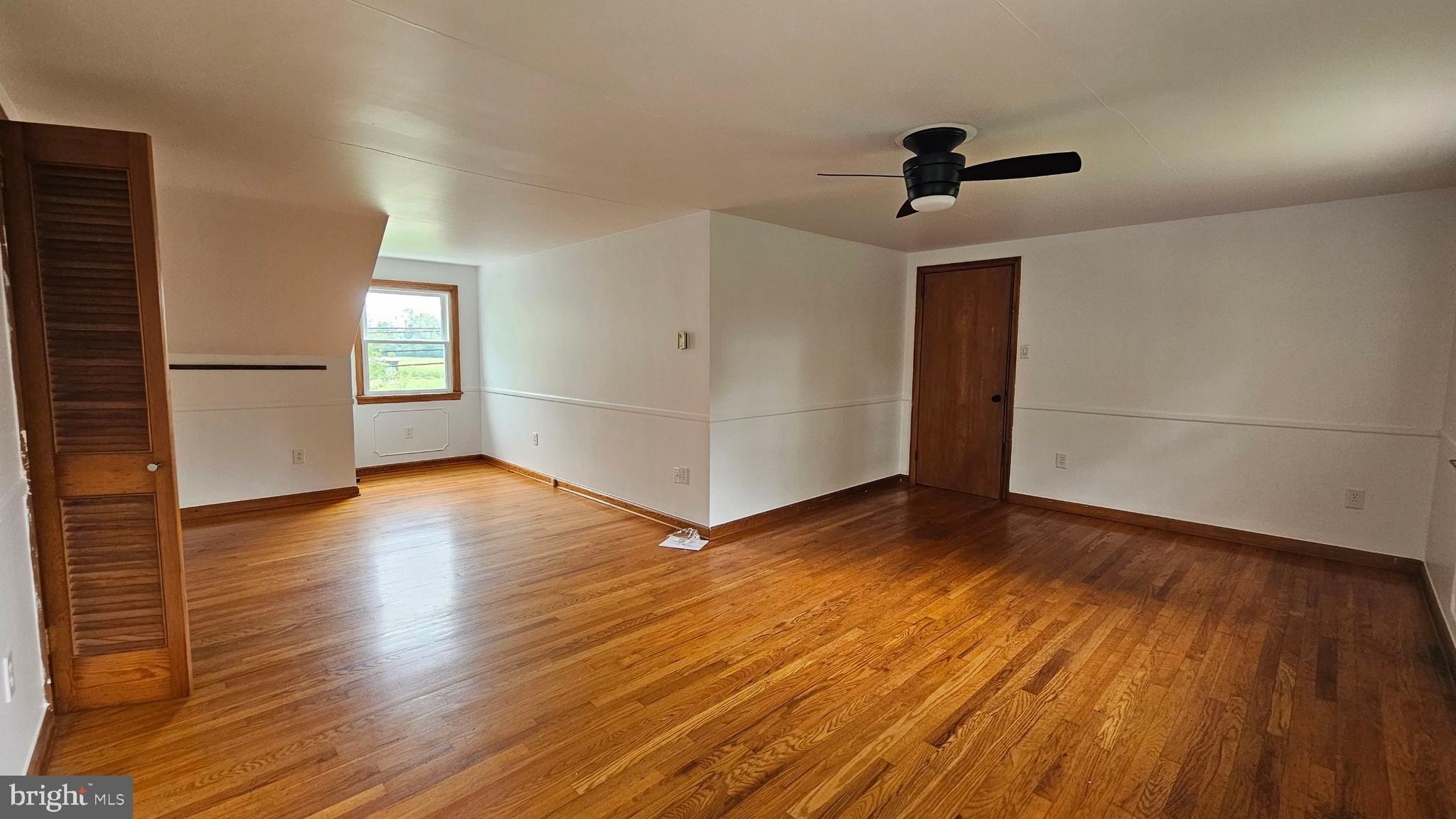 262 Roadstown Road Bridgeton, NJ 08302 - Photo 22 of 25 an empty room with wooden floor cabinet and windows