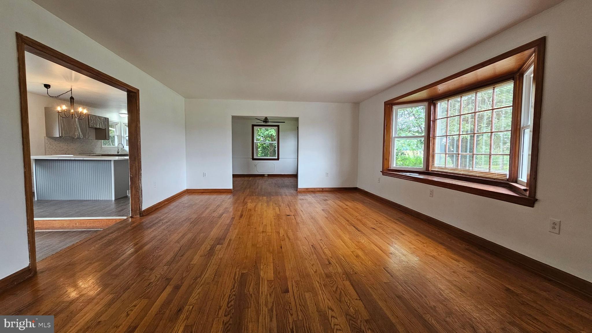 262 Roadstown Road Bridgeton, NJ 08302 - Photo 3 of 25 an empty room with wooden floor and windows
