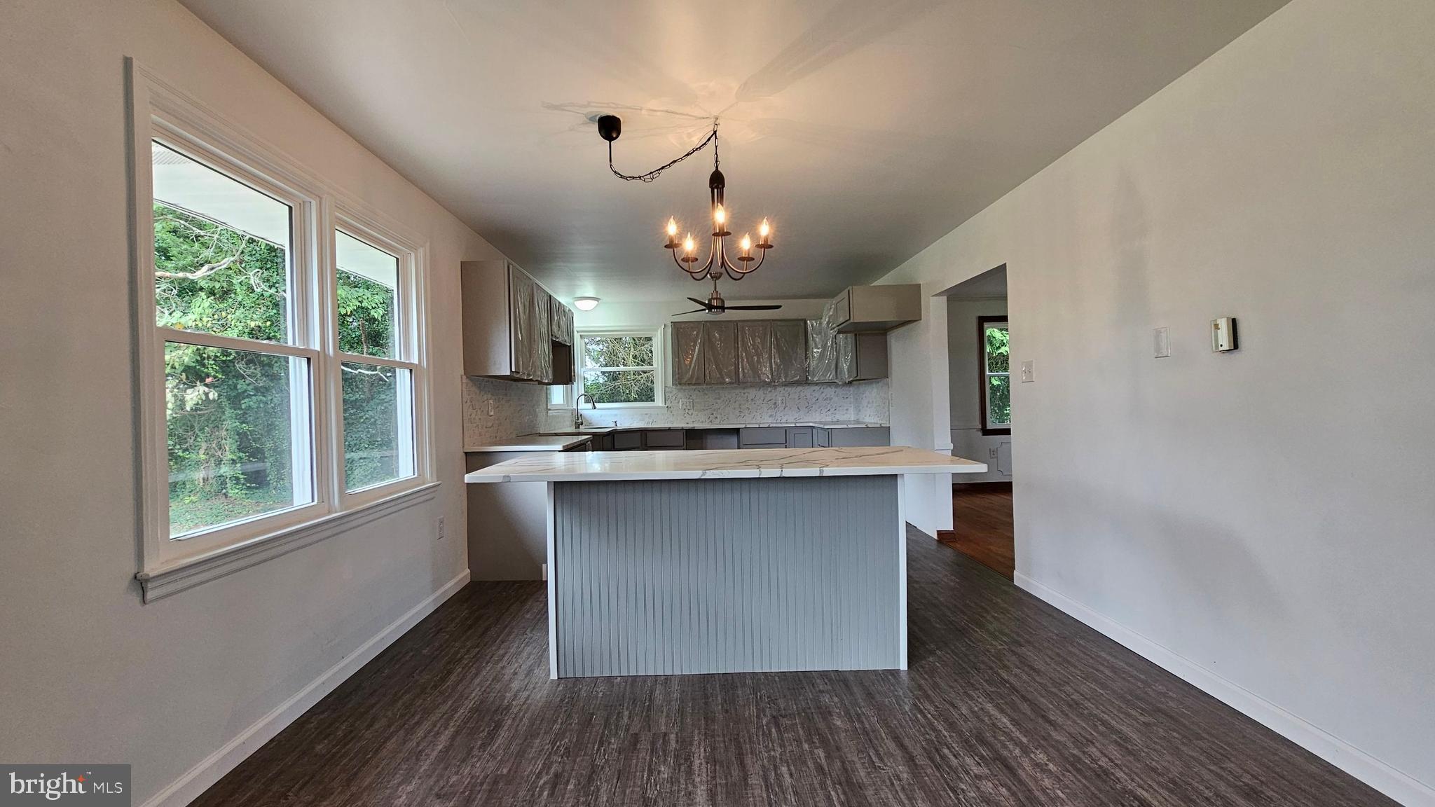 262 Roadstown Road Bridgeton, NJ 08302 - Photo 10 of 25 a kitchen with kitchen island granite countertop a sink cabinets and wooden floor