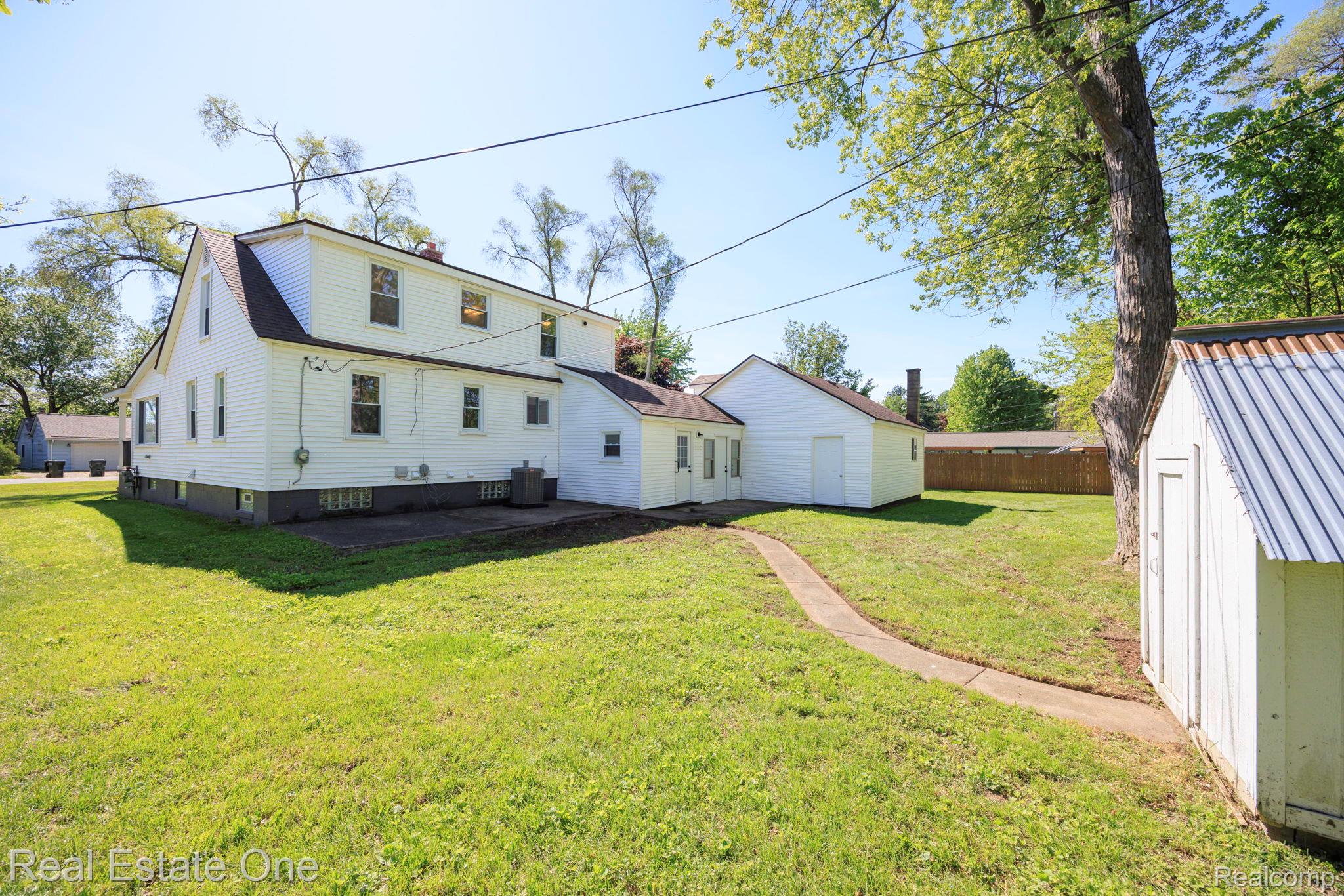 3200 Hessel Avenue Rochester, MI 48307 - Photo 27 of 32 Back of property with a storage unit and a patio area