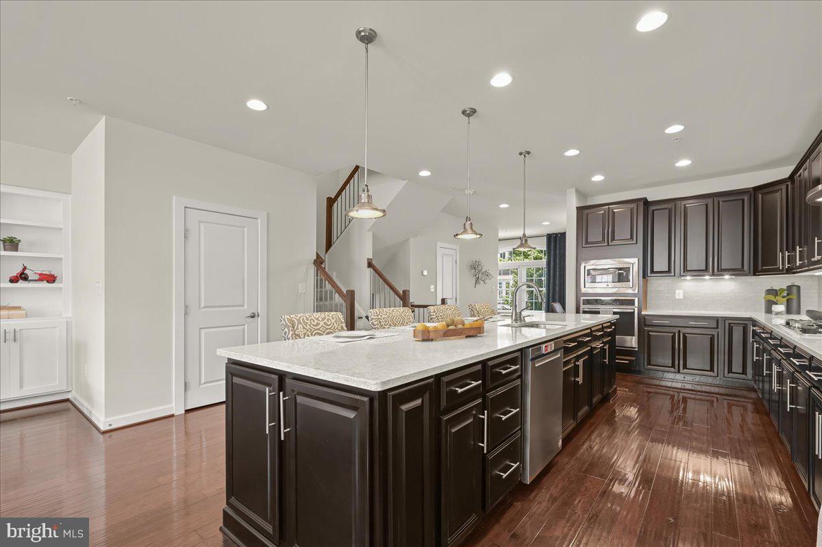 11285 Terrace Lane Fulton, MD 20759 - Photo 13 of 52 a kitchen with a stove a sink a refrigerator and a wooden cabinets