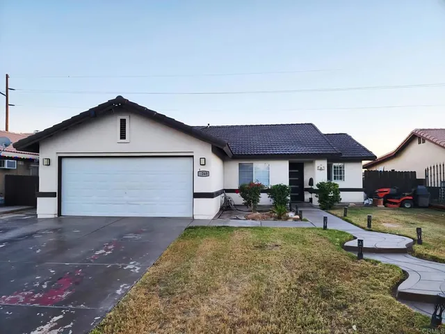 a front view of house with yard and outdoor seating