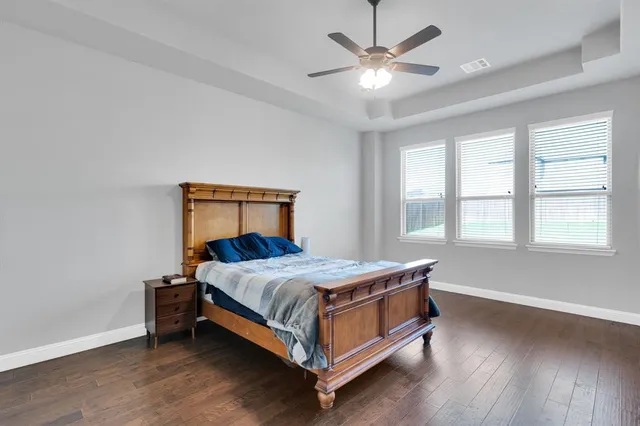a bed sitting in a bedroom next to a window