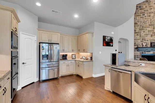 a kitchen with cabinets and stainless steel appliances