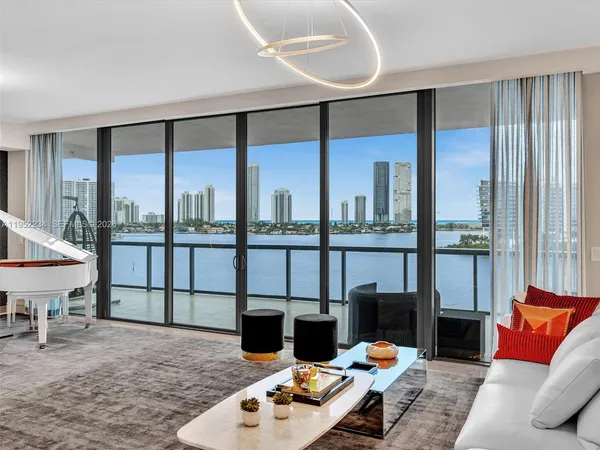 a bedroom with furniture and a large window