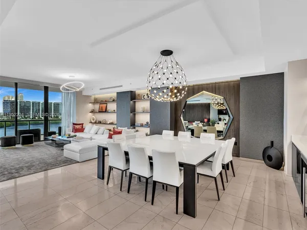 a view of a dining room with furniture and chandelier