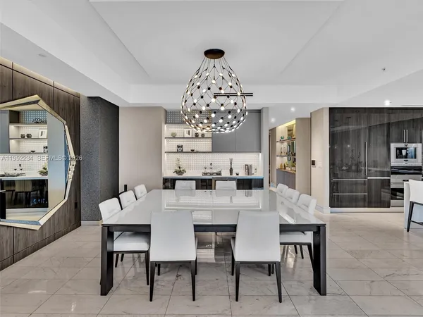 a view of a dining room with furniture and chandelier