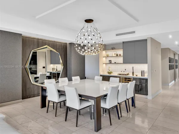 a view of a dining room with furniture and chandelier