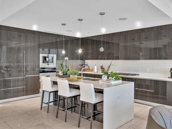 a kitchen with a dining table chairs and microwave