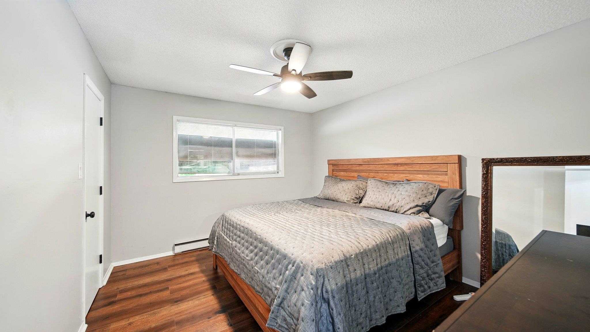 359 South Fenwick Road Memphis, TN 38111 - Photo 20 of 31 Bedroom with wood finished floors, baseboard heating, and a ceiling fan