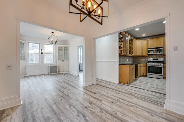 a view of kitchen with cabinets and wooden floor
