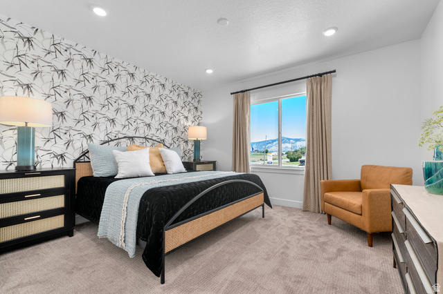 1418 West 2350th South, Unit 15 Perry, UT 84302 - Photo 11 of 22 Bedroom featuring a decorative accent wall, recessed lighting, and a large window with mountain scenery