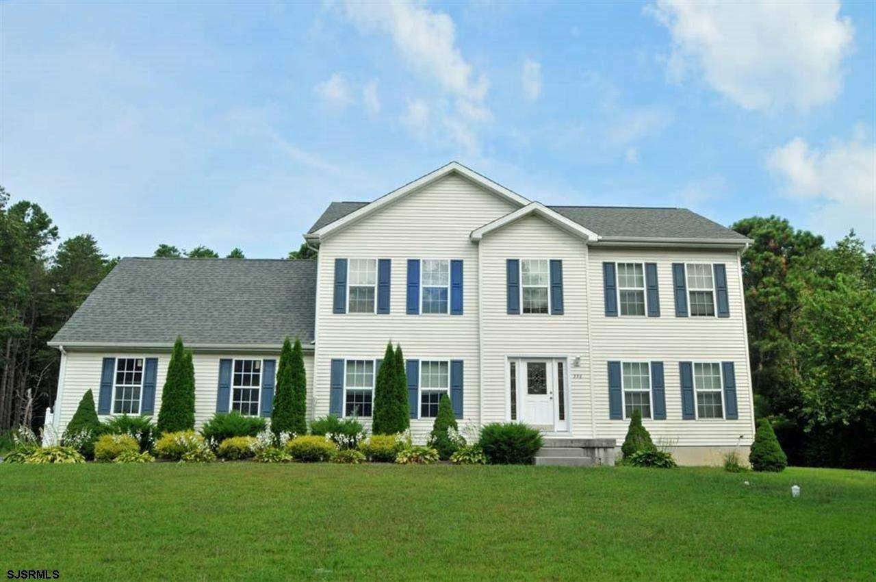 330 Stagecoach Road Marmora, NJ 08223 - Photo 1 of 1 a front view of a house with a yard and trees