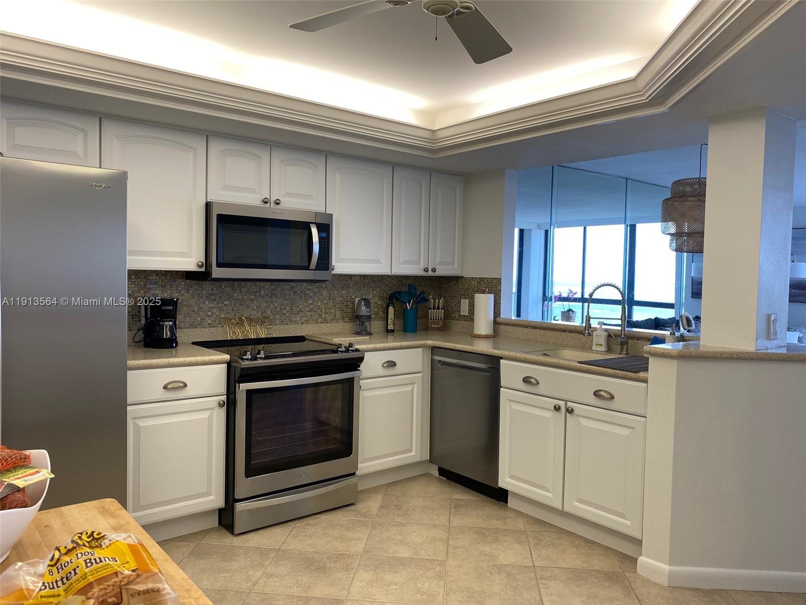 2800 North Hwy A1A, Unit 803 Fort Pierce, FL 34949 - Photo 13 of 35 a kitchen with a sink stove and microwave