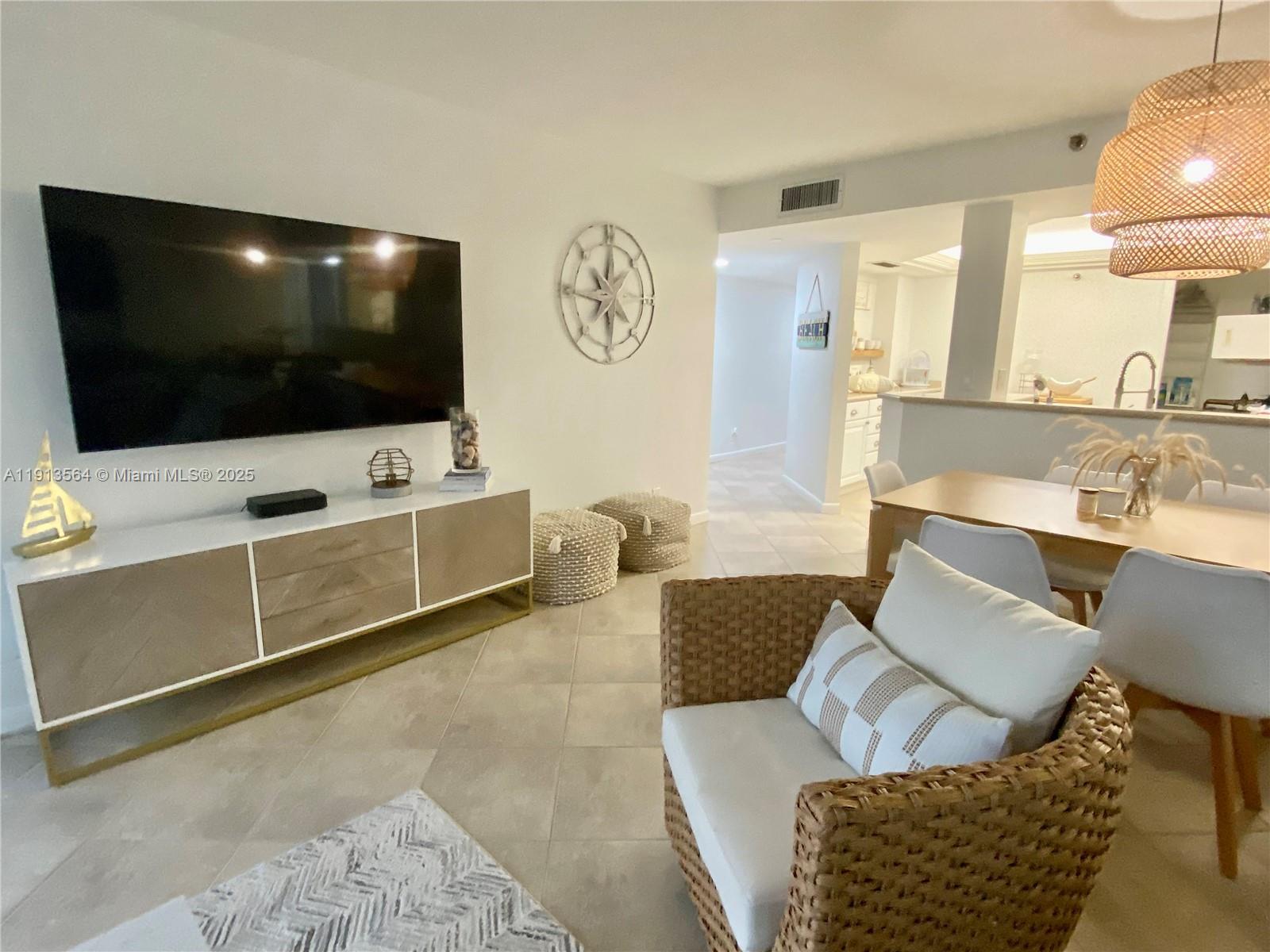 2800 North Hwy A1A, Unit 803 Fort Pierce, FL 34949 - Photo 14 of 35 a living room with furniture and a flat screen tv