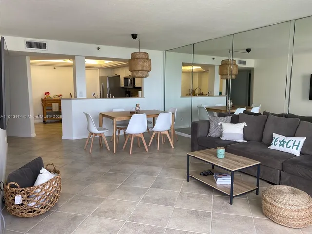 a living room with a flat screen tv and a potted plant
