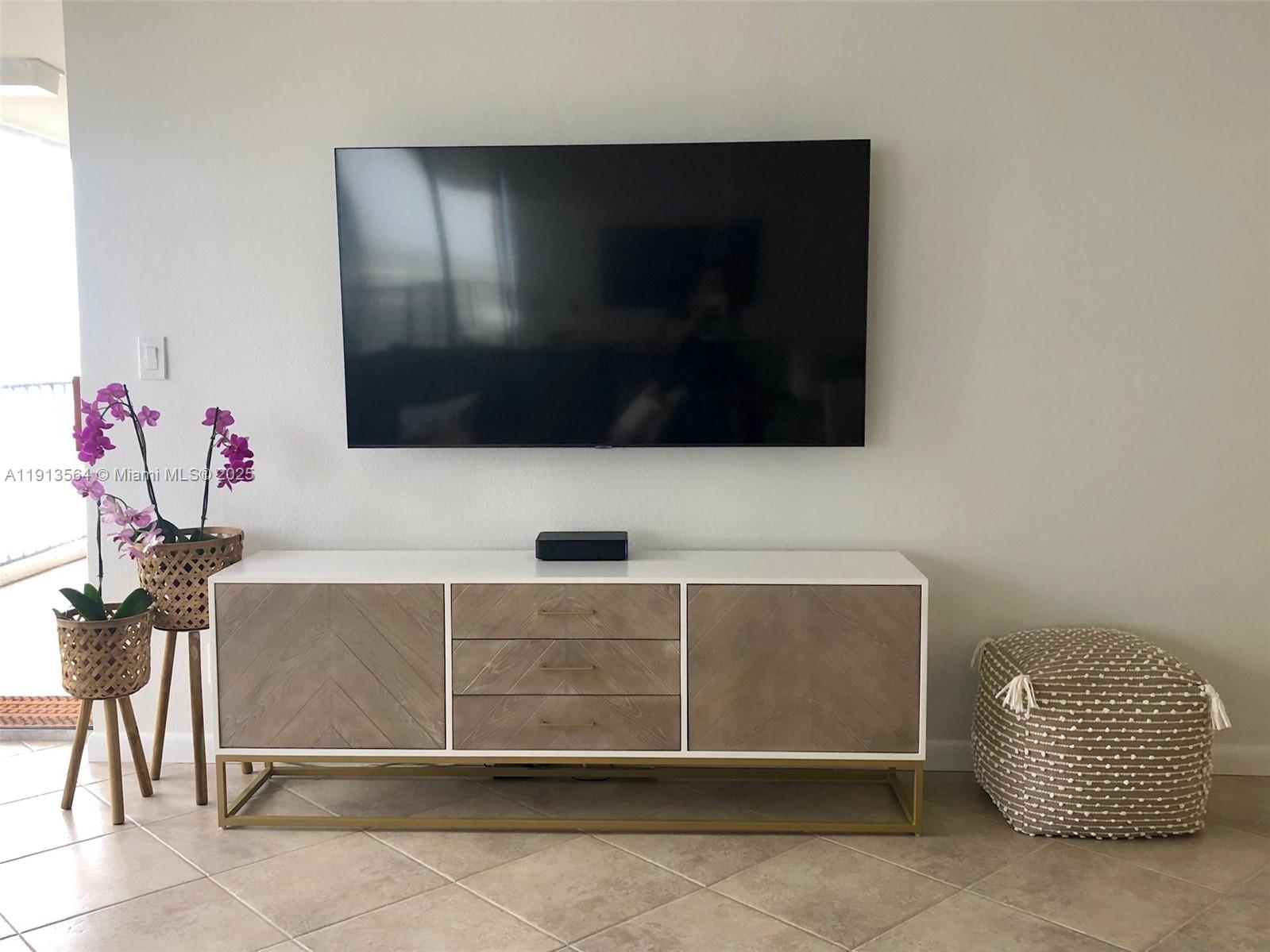 2800 North Hwy A1A, Unit 803 Fort Pierce, FL 34949 - Photo 17 of 35 a living room with a flat screen tv and a potted plant