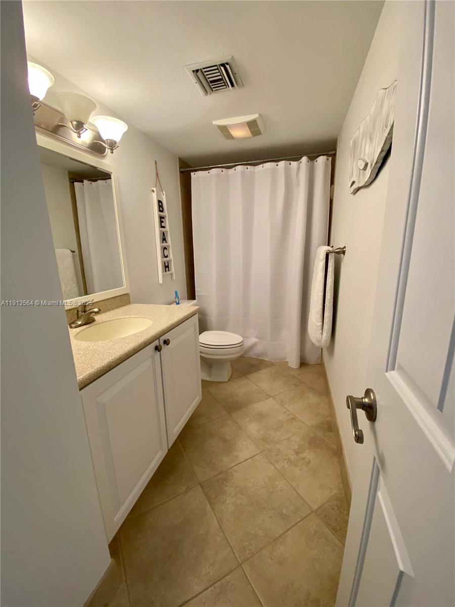 2800 North Hwy A1A, Unit 803 Fort Pierce, FL 34949 - Photo 23 of 35 a bathroom with a sink a toilet and shower