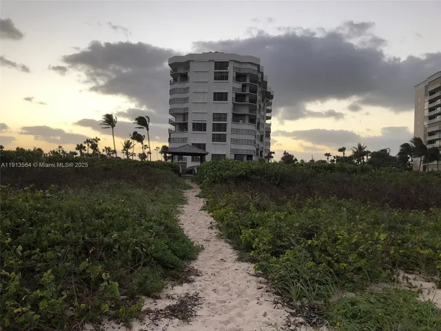 a living room with furniture large window and wooden floor