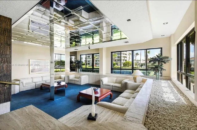 a view of building with lot of cars and trees