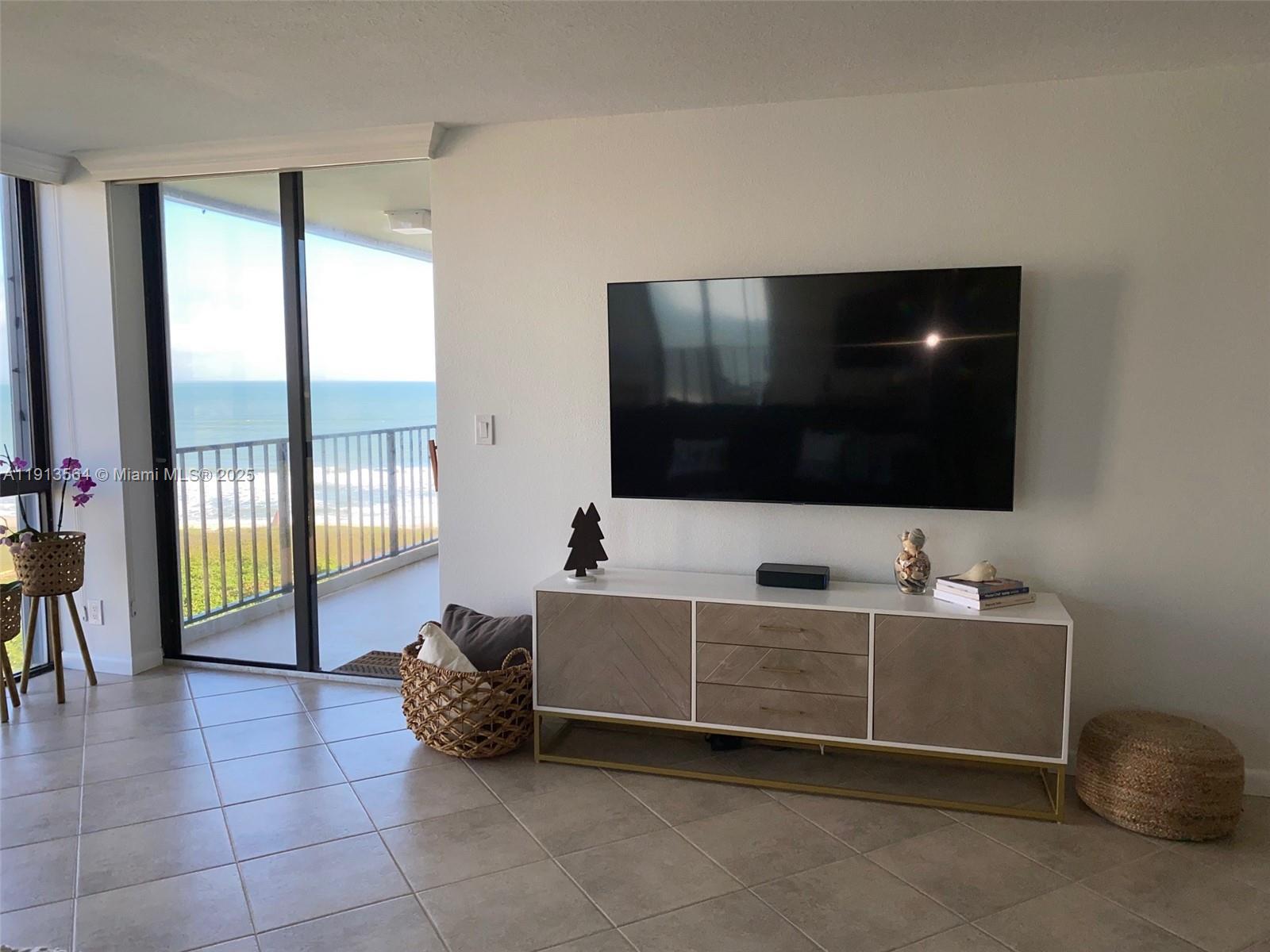 2800 North Hwy A1A, Unit 803 Fort Pierce, FL 34949 - Photo 5 of 35 a living room with furniture and a flat screen tv