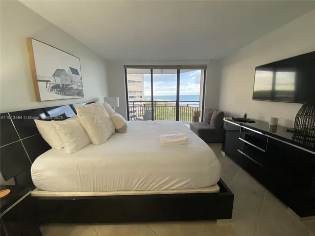 a bedroom with a bed and a lamp