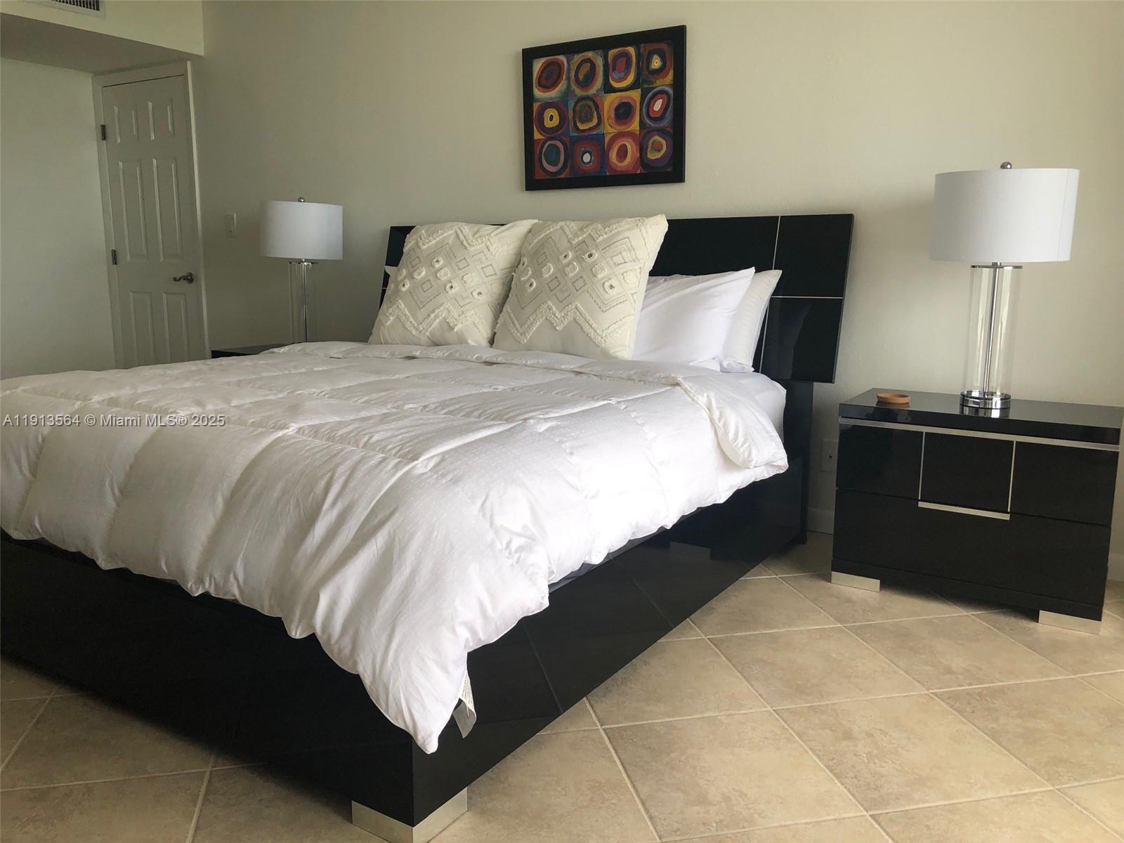 2800 North Hwy A1A, Unit 803 Fort Pierce, FL 34949 - Photo 7 of 35 a bedroom with a bed and a lamp