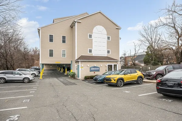 a view of cars parked in front of a house