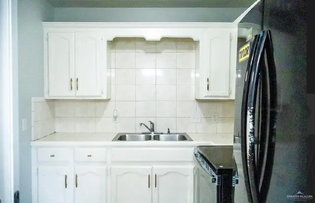 a kitchen with a sink and cabinets