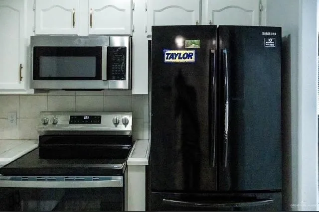 a kitchen with a stove and a microwave