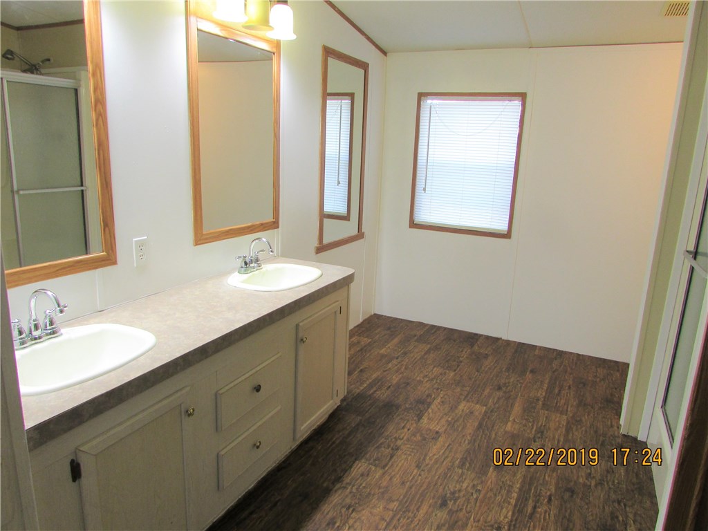 371673 Kings Ferry Road Hilliard, FL 32046 - Photo 11 of 34 a bathroom with a sink and a mirror