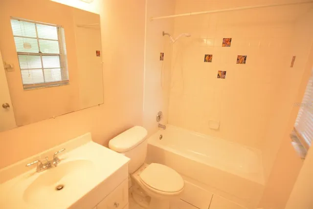 a white toilet sitting next to a bathroom sink