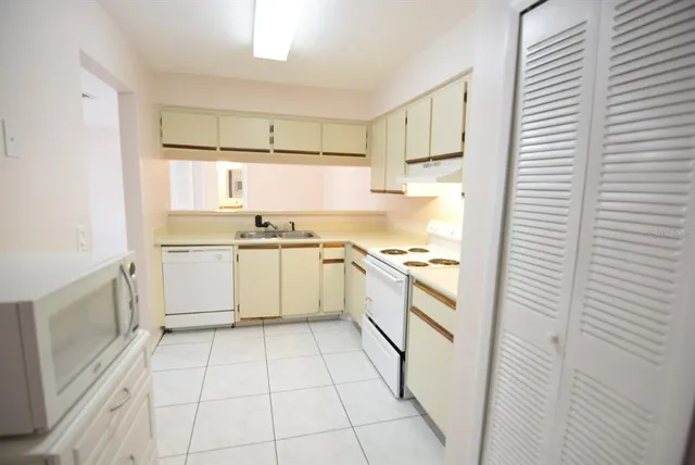 a kitchen with a stove a sink and a refrigerator