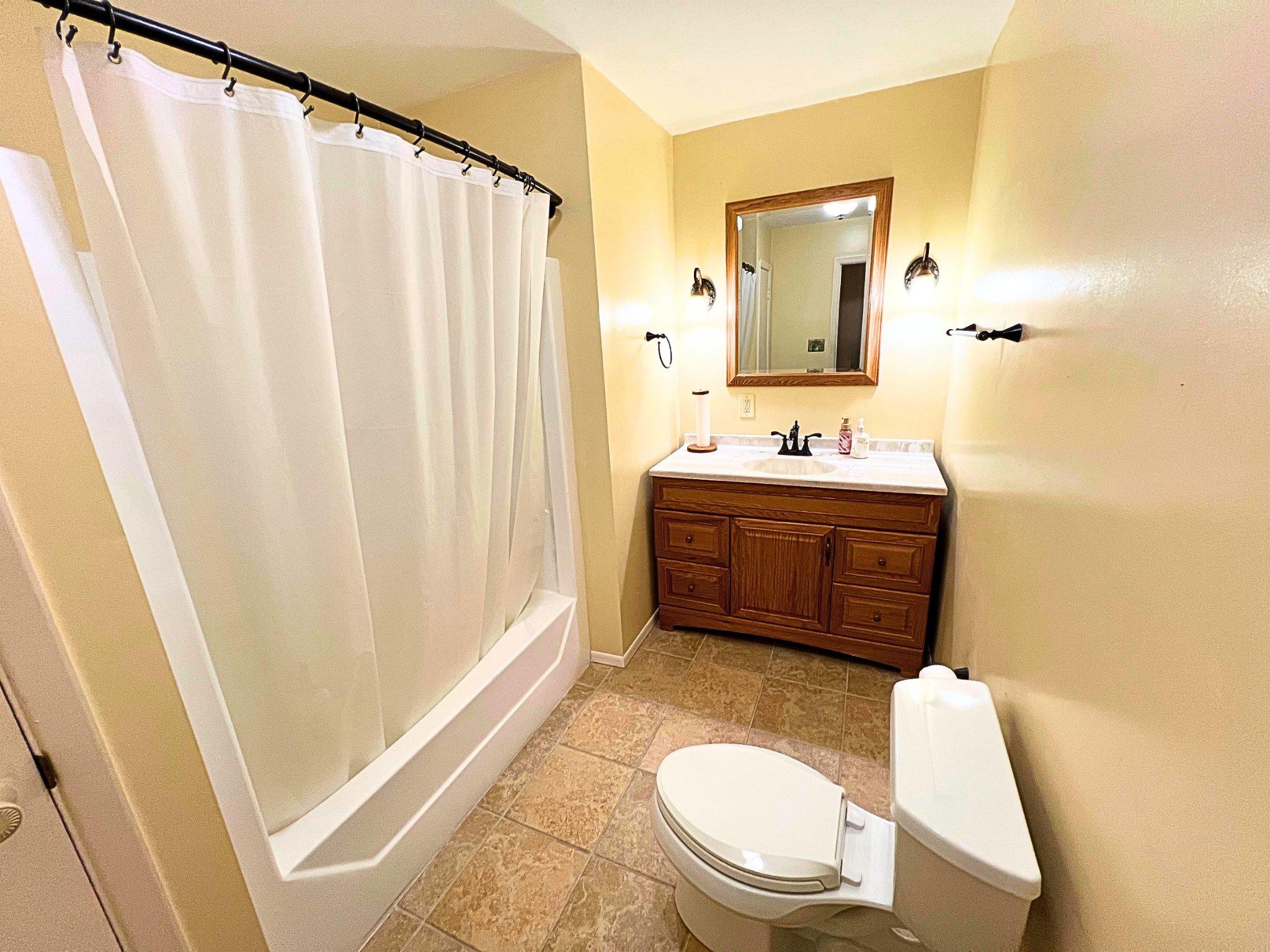 8531 Solomons Island Road North Owings, MD 20736 - Photo 6 of 12 a bathroom with a sink a toilet and mirror