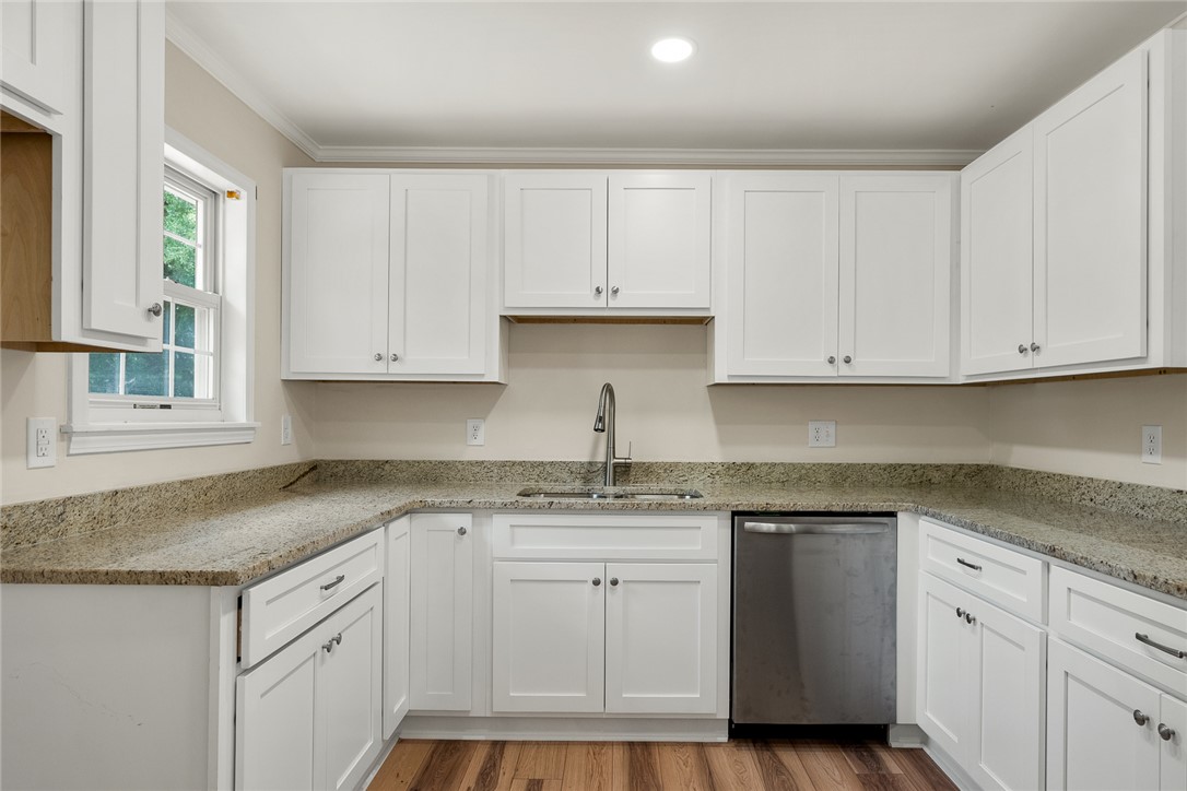 131 Lockaby Road Pelzer, SC 29669 - Photo 19 of 50 Bright and inviting, this kitchen features ample cabinetry, gleaming countertops, and durable flooring.
