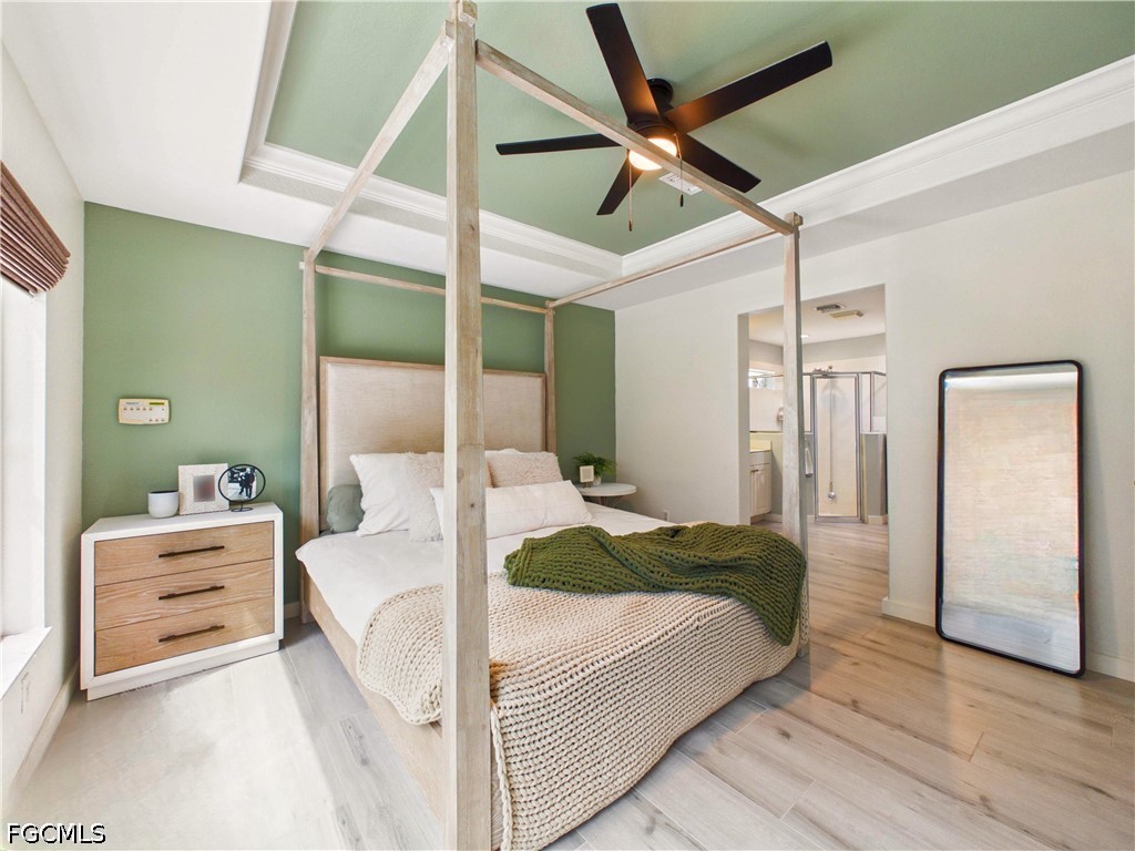 19694 Villa Rosa Loop Estero, FL 33967 - Photo 17 of 28 a bedroom with a large bed and a chandelier